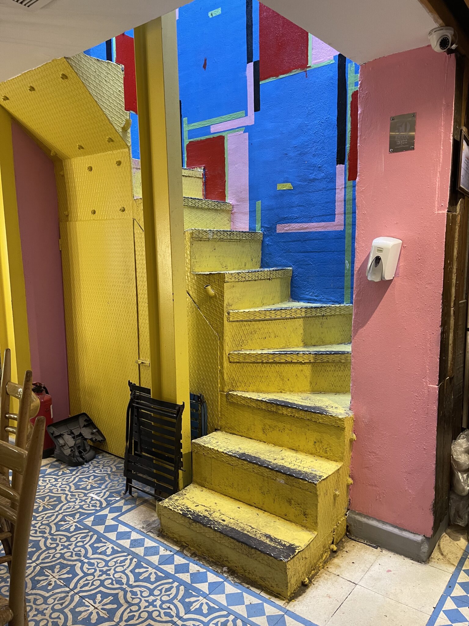 yellow stairs pink walls tiled floors